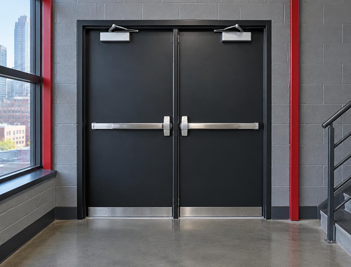 Heavy-duty commercial double doors with panic exit bars and overhead closers